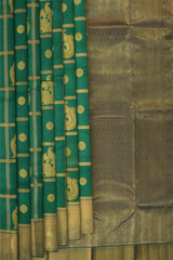 Green Kanchipuram Silk Saree with Annam checks on the body with Blue contrast border and Blue Grand Peacock Motif Pallu with Diamond Design