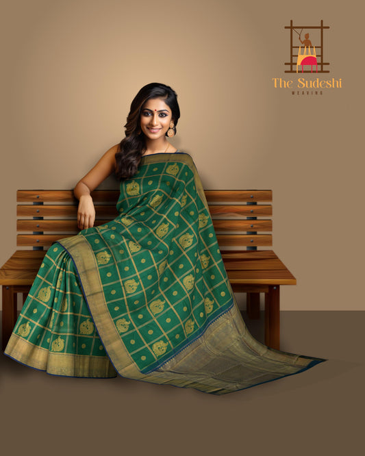 Green Kanchipuram Silk Saree with Annam checks on the body with Blue contrast border and Blue Grand Peacock Motif Pallu with Diamond Design