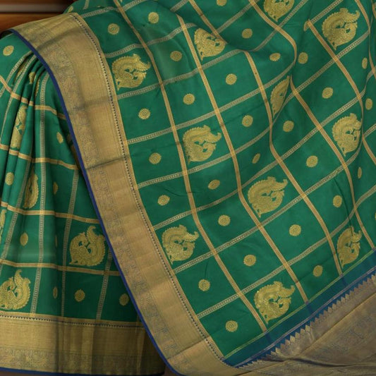 Green Kanchipuram Silk Saree with Annam checks on the body with Blue contrast border and Blue Grand Peacock Motif Pallu with Diamond Design