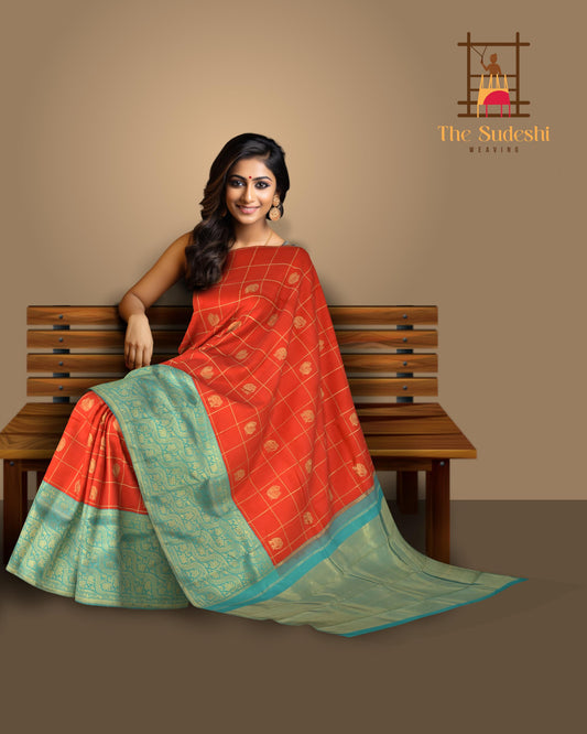 Chilli Red Kanchipuram Silk Saree with Checks on the body with Turqoise Blue contrast Lotus Border and Blue Blue Tissue Pallu. Grand.