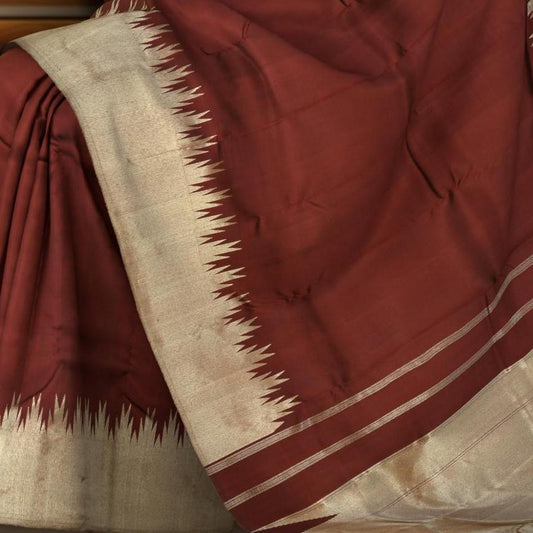 Maroon Kanchipuram Silk Saree with temple border on the body with Maroon self border and Maroon Grand Tissue Pallu