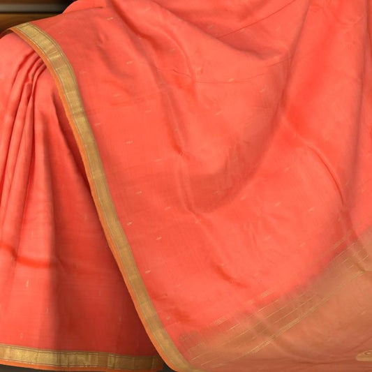 Coral Pink Color Kanchipuram Silk Saree with Silk Saree Small Gold s plain design on the body with cross lines contrast border and Dual Tone Dull Greenish Peach with big mango motif pallu.