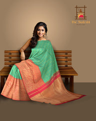 Coral Pink Confluence Pure Kanchipuram Silk Saree with Blue Floral Buttas