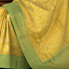 Yellow Kanchipuram Silk Saree with pink flower designs on the body with pista green contrast border and grand floral design with diamond motif in pallu