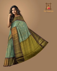 Light Blue Kanchipuram Tissue Silk Saree with embossed designs on the body with violet contrast border and annam, gatti pallu, and grand designs in pallu