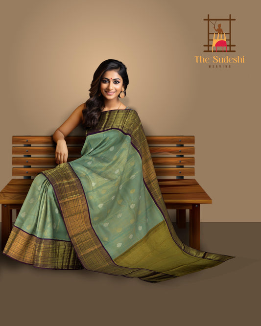 Light Blue Kanchipuram Tissue Silk Saree with embossed designs on the body with violet contrast border and annam, gatti pallu, and grand designs in pallu