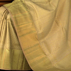 Biege Kanchipuram Silk Saree with motif and jacquard designs on the body with self diamond design with kamalam motif border and diamond and floral grand pallu designs