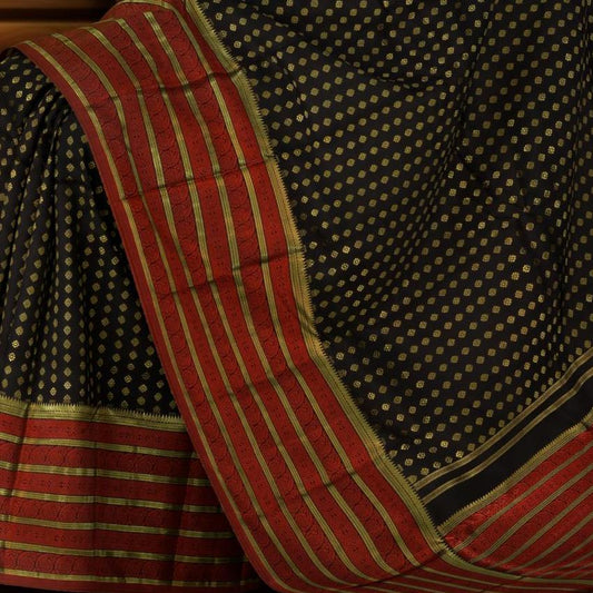 Black Kanchipuram Silk Saree with vertical chakram butta, brocade design on the body with red contrast border and rope design with red threadwork pallu