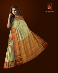 Light Green Kanchipuram Silk Saree with Tissue, Embossed, Meenakari, Brocade on the body with red contrast border and pallu featuring rudraksham, grand, creeper design with rich pallu