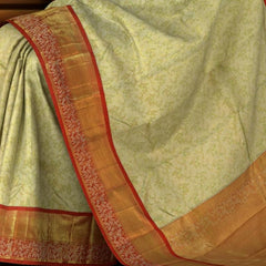 Light Green Kanchipuram Silk Saree with Tissue, Embossed, Meenakari, Brocade on the body with red contrast border and pallu featuring rudraksham, grand, creeper design with rich pallu