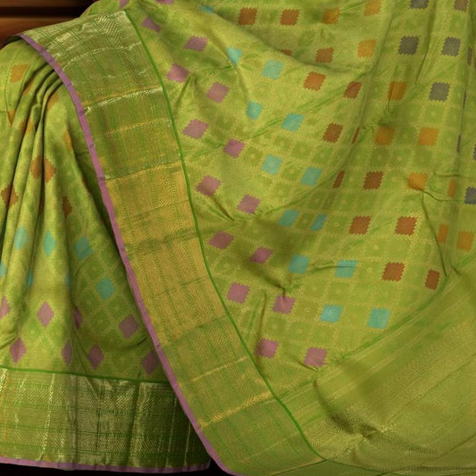 Lime green Kanchipuram Silk Saree with Tissue, Embossed, Meenakari, Diamond design with multicolour threadwork on the body with light green with lavender selvage contrast border and pallu featuring grand, floral intricately designed grand pallu