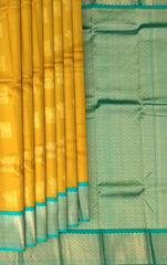 Luminous Yellow Kanchipuram Silk Saree with Elegant Bhuttas - Vibrant Traditions
