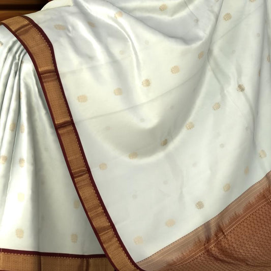 White Kanchipuram Silk Saree with Maroon Border and Floral Buttas