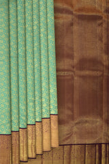Copper Sulphate Blue Kanchipuram Silk Saree with Floral Jackard on the body with Wine Purple contrast border and Wine Purple Grand Pallu with mango design pallu
