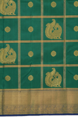 Green Kanchipuram Silk Saree with Annam checks on the body with Blue contrast border and Blue Grand Peacock Motif Pallu with Diamond Design