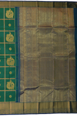 Green Kanchipuram Silk Saree with Annam checks on the body with Blue contrast border and Blue Grand Peacock Motif Pallu with Diamond Design