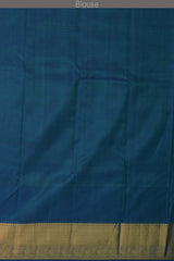 Green Kanchipuram Silk Saree with Annam checks on the body with Blue contrast border and Blue Grand Peacock Motif Pallu with Diamond Design