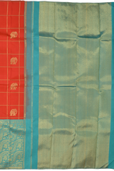 Chilli Red Kanchipuram Silk Saree with Checks on the body with Turqoise Blue contrast Lotus Border and Blue Blue Tissue Pallu. Grand.