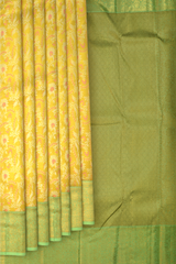 Yellow Kanchipuram Silk Saree with pink flower designs on the body with pista green contrast border and grand floral design with diamond motif in pallu