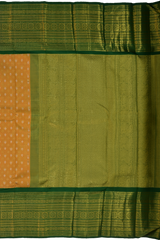 Light Orange Kanchipuram Tissue Silk Saree embossed, and intricately designed silver and gold butta on the body with leaf green contrast border and annam, grand, kuyil kan designs in pallu