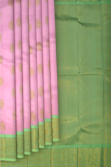 Rose milk pink Kanchipuram Silk Saree with Motif on the body with pista green contrast border and pallu featuring annam, rudraksham, grand, zig zag pattern intricately designed