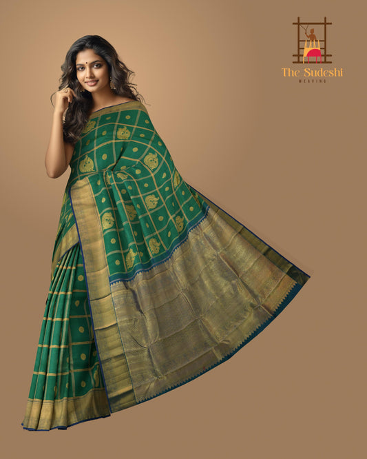 Green Kanchipuram Silk Saree with Annam checks on the body with Blue contrast border and Blue Grand Peacock Motif Pallu with Diamond Design