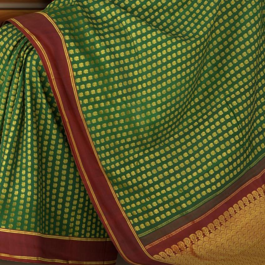 Bottle Green Kanchipuram Silk Saree with Butta peacock on the body with Maroon contrast border and Grand Maroon Pallu Intricately design Semi circle pattern with mango motif