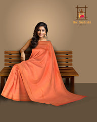 Orange Kanchipuram Silk Saree with Small Butta jackard on the body with zig zag self border and Intricately designed copper zari pallu.