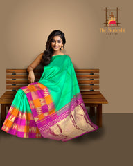 Sea Green Kanchipuram Silk Saree with Pink-Orange Zigzag Border and Triangle Motif Checks – A Vibrant Celebration in Silk