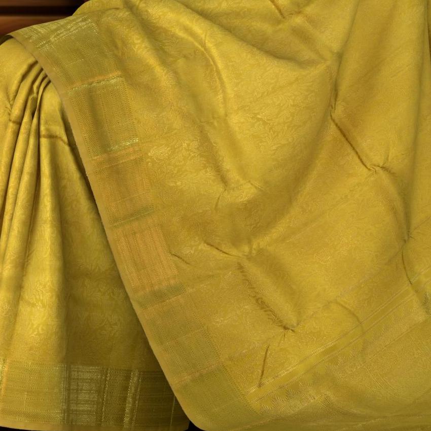 Mustard Kanchipuram Silk Saree with floral and jacquard designs on the body with self lotus border and rudraksham, ashwa motif, and temple designs in pallu