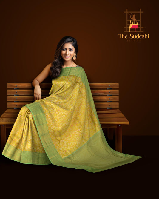 Yellow Kanchipuram Silk Saree with pink flower designs on the body with pista green contrast border and grand floral design with diamond motif in pallu