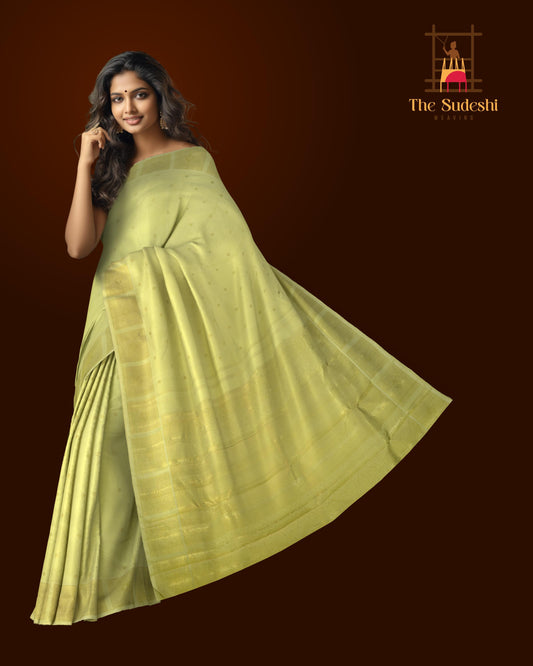 Cardamom Light Green Kanchipuram Silk Saree with small round butta design on the body with self unique block checks border and grand pallu with kuyil kan and retta kili (2 parrots) designs