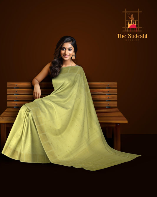 Cardamom Light Green Kanchipuram Silk Saree with small round butta design on the body with self unique block checks border and grand pallu with kuyil kan and retta kili (2 parrots) designs