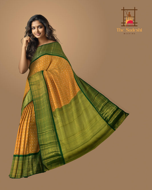 Light Orange Kanchipuram Tissue Silk Saree embossed, and intricately designed silver and gold butta on the body with leaf green contrast border and annam, grand, kuyil kan designs in pallu