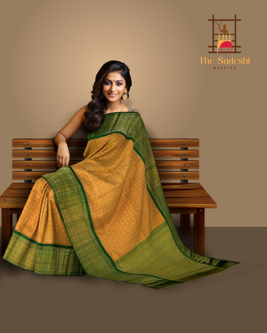 Light Orange Kanchipuram Tissue Silk Saree embossed, and intricately designed silver and gold butta on the body with leaf green contrast border and annam, grand, kuyil kan designs in pallu