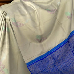 Elegant Beige Kanchipuram Silk Saree with Majestic Peacock Threadwork