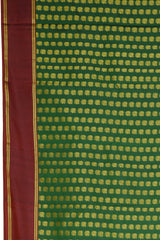 Bottle Green Kanchipuram Silk Saree with Butta peacock on the body with Maroon contrast border and Grand Maroon Pallu Intricately design Semi circle pattern with mango motif